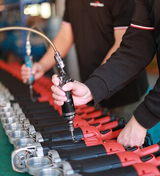 Skilled technician assembling SHINE TECH industrial polisher at factory